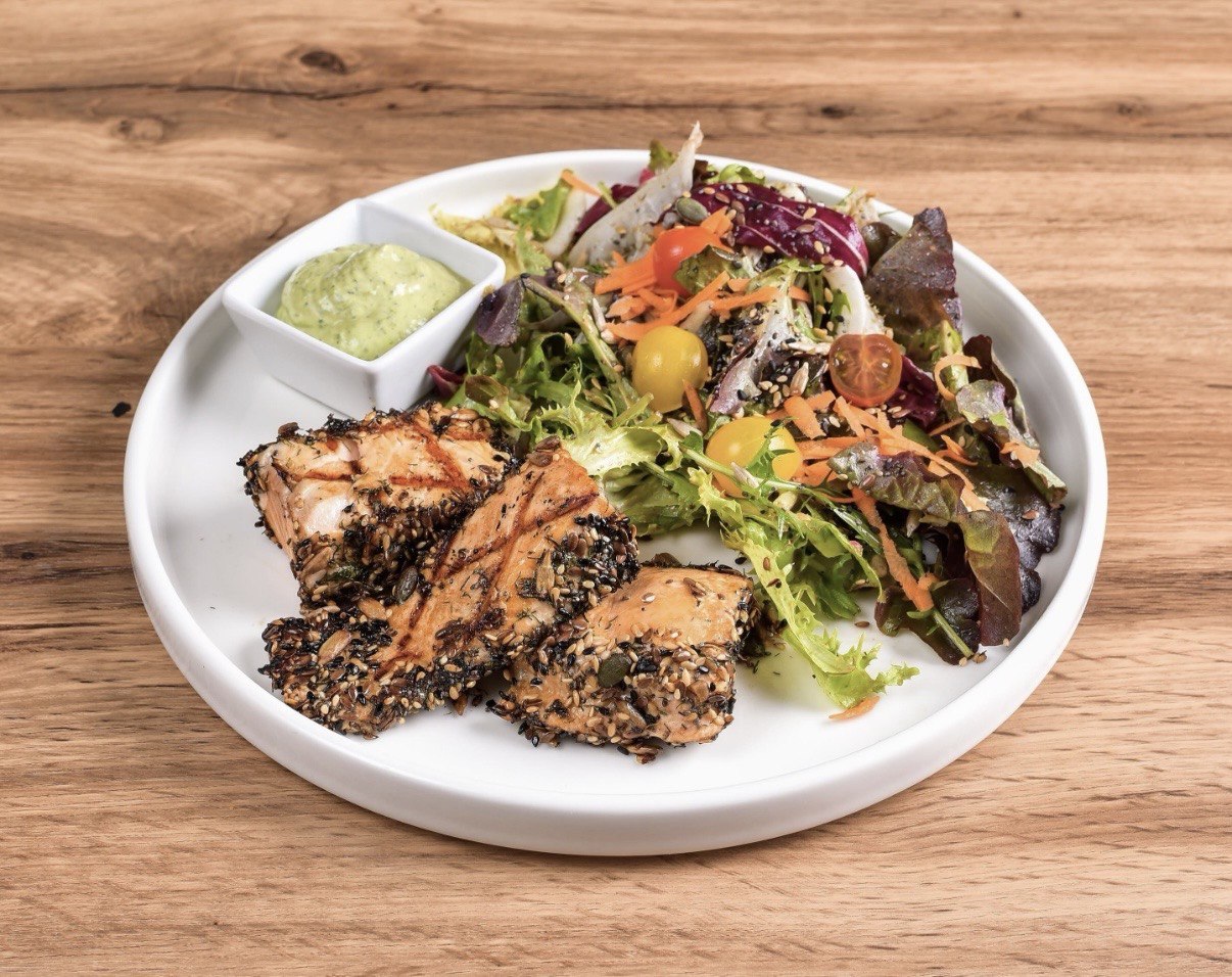 Salmon loin with toasted seeds, salad and green sauce, a gluten free dish at Gato Blanco