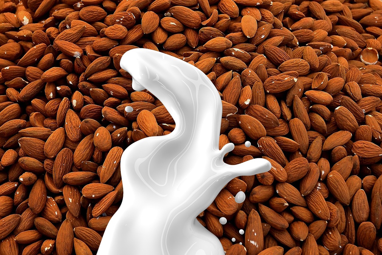 A glass of almond milk on a table, a plant-based lactose-free alternative